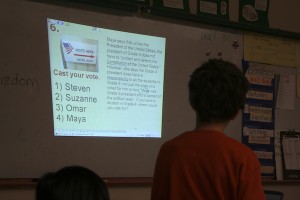 Grade 4 student casts vote using student response clicker.  